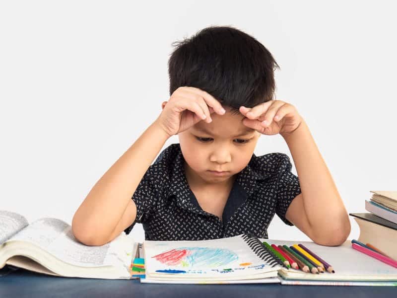 boy is unhappy doing homework