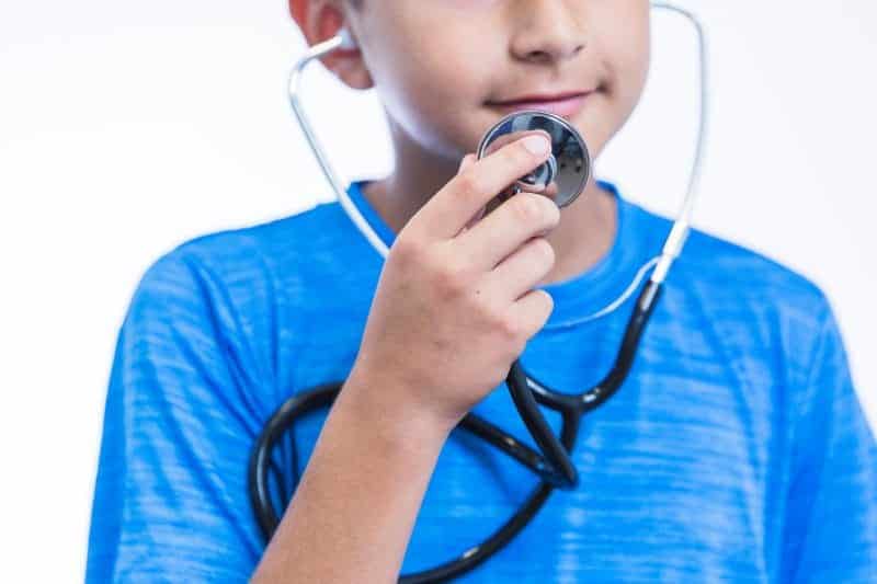 close up boy holding stethoscope