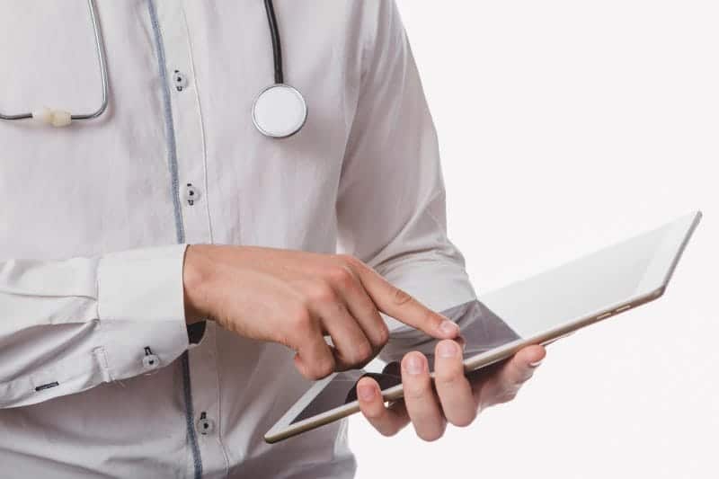 doctor tapping tablet