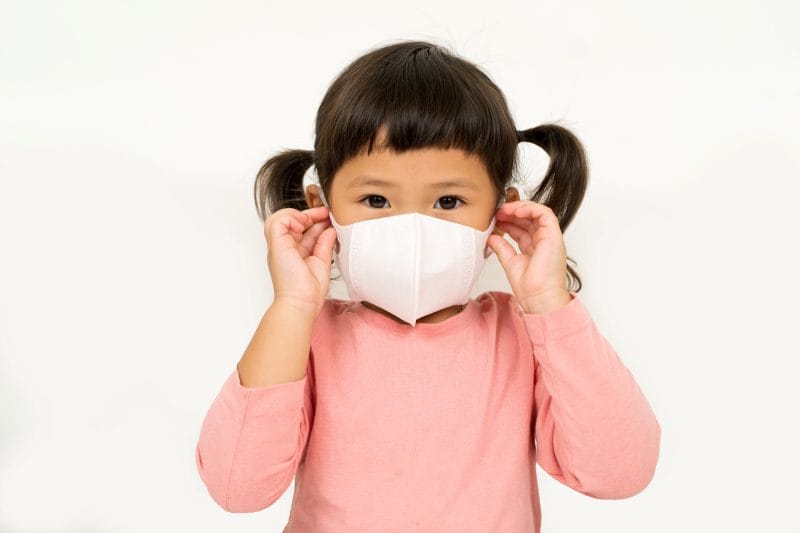 little asian girl wearing mask protect