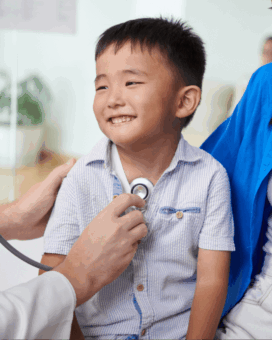 Blog 2 smiling boy looking doctor, paediatrician visit warning signs
