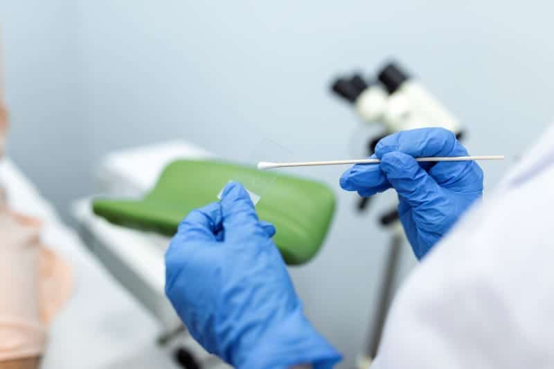 vaginal smear closeup doctor hand holds gynecological examination instruments gynecologist working obstetrics gynecology clinic